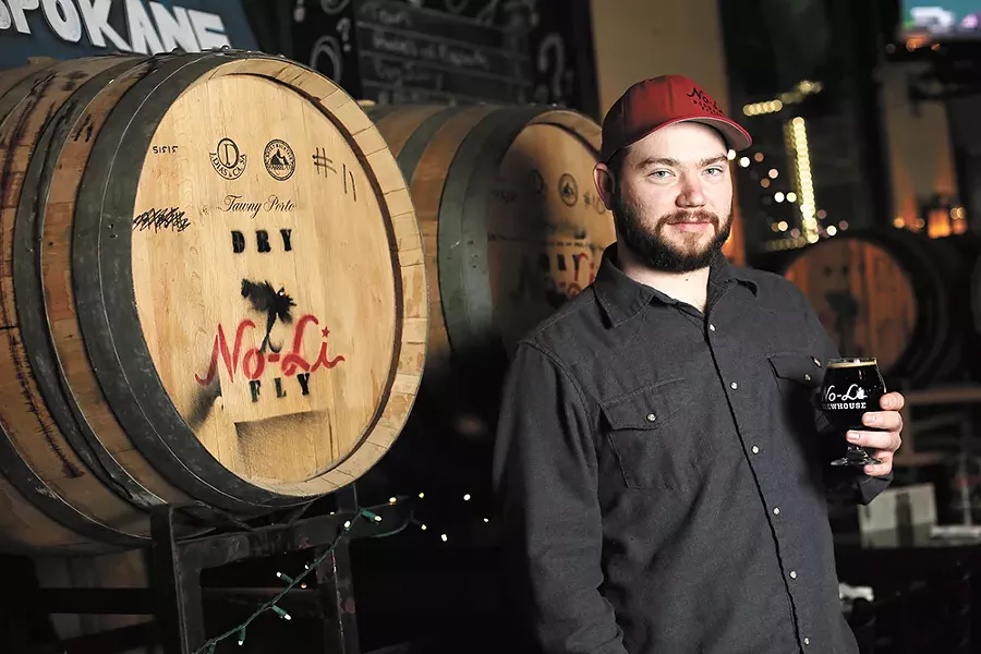 No-Li head brewer Ryan Brookhart with a glass of "Rip Van Winkle," a whiskey barrel-aged imperial stout. - YOUNG KWAK