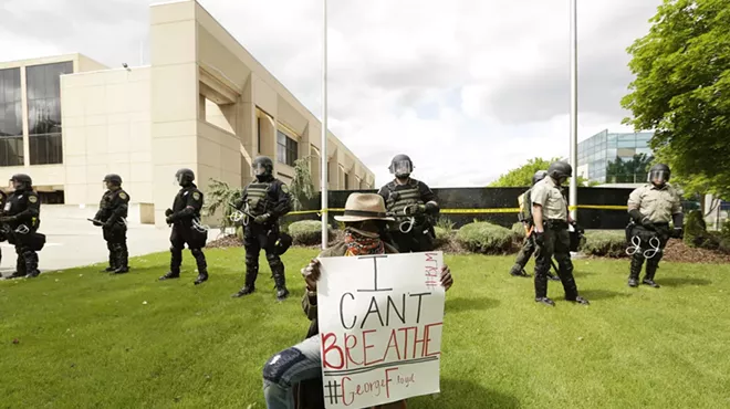Demonstrators face-off with police officers and deputies at the county courthouse.
