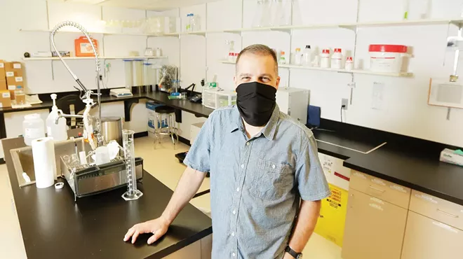 At GenPrime's Spokane lab, Buck Somes says the company's Reader offers improved accuracy in reading and recording coronavirus test results.|young kwak photo