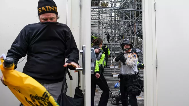 A protester breaches a security door at the Capitol in Washington and is met by police officer, Jan 6, 2020. The Capitol building was placed on lockdown, with senators and members of the House locked inside their chambers, as Congress began debating President-elect Joe Biden&rsquo;s victory. President Trump addressed supporters near the White House before protesters marched to Capitol Hill.