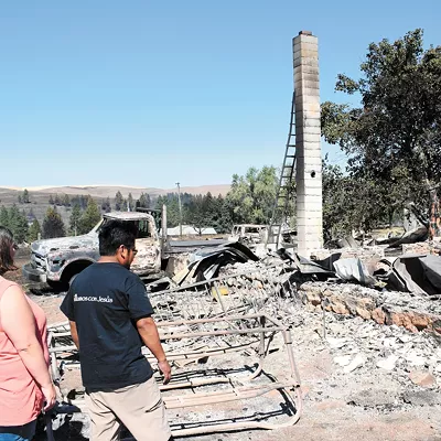 Alfredo and Maria Castillo search for their dog, Toto, in the remains of their house in Malden.