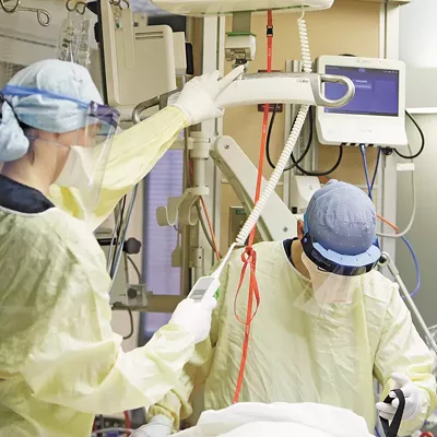 Nurse Christie Charbonneau, left, and respiratory therapist John Frostad treat an ICU patient at MultiCare Deaconess Hospital on Sept. 17.