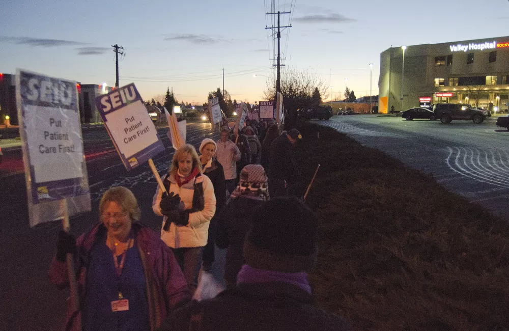 Union members and supporters march outside Valley Hospital as the sun comes up on Wednesday. - JACOB JONES