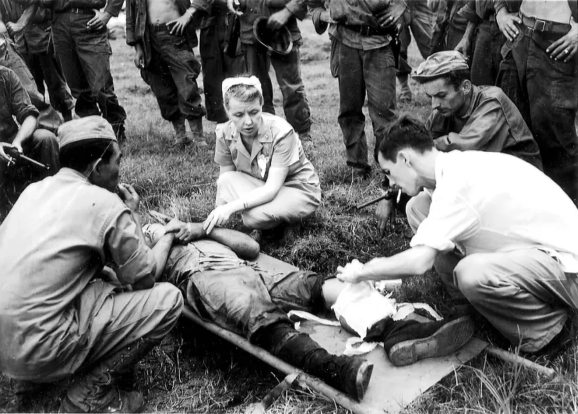 U.S. Army Nurse Frankie Lewey treating a wounded man shortly after the February 3, 1945, liberation of Santo Tomas Internment Camp in Manila, Philippines.