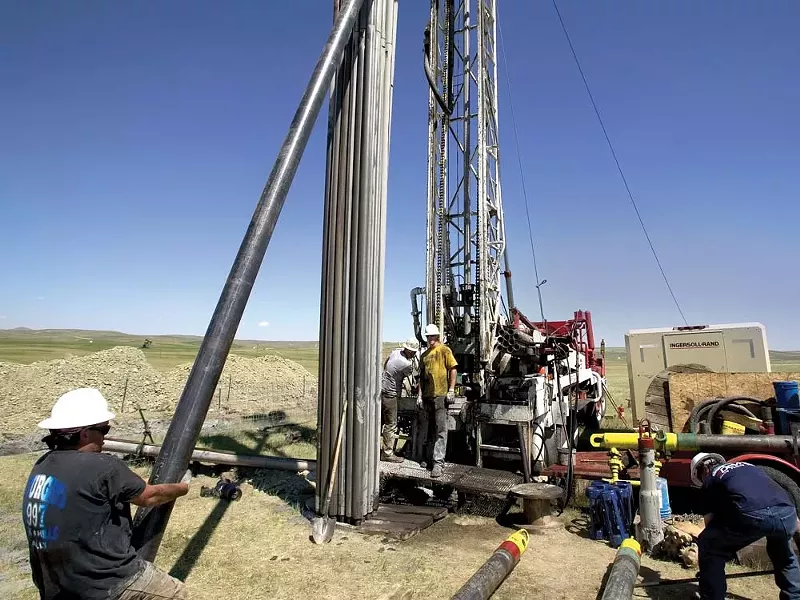 Workers at a natural gas well In Wyoming. - ROBERT NICKELSBERG PHOTO/GETTY IMAGES