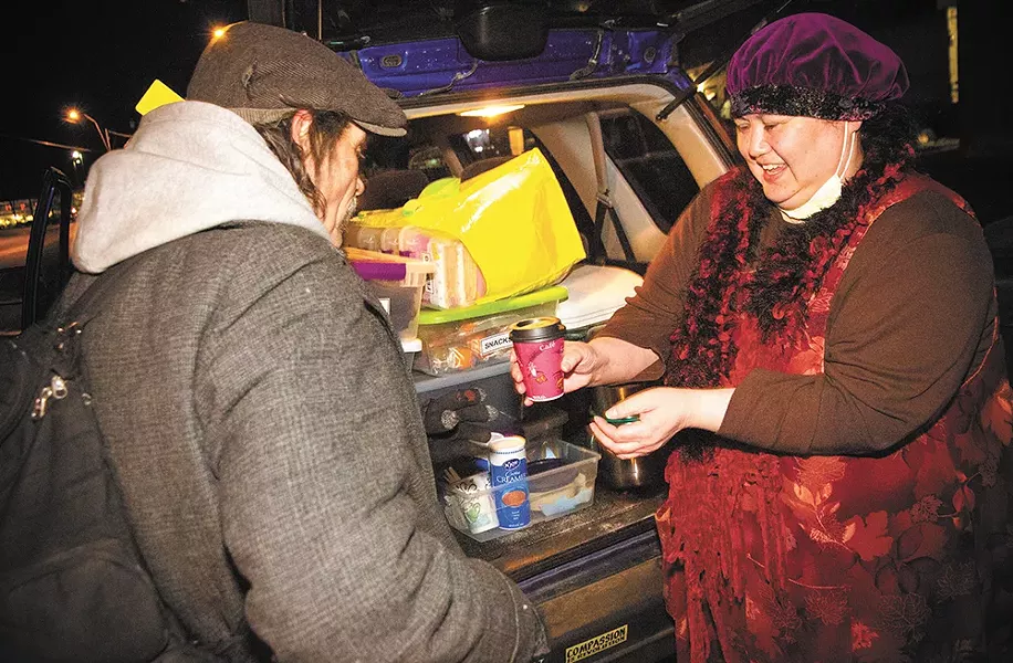 "You're a saint!" says Jimbo, a homeless Spokane man, as Joan Medina serves a warm cup of coffee to him. - JENNIFER DEBARROS