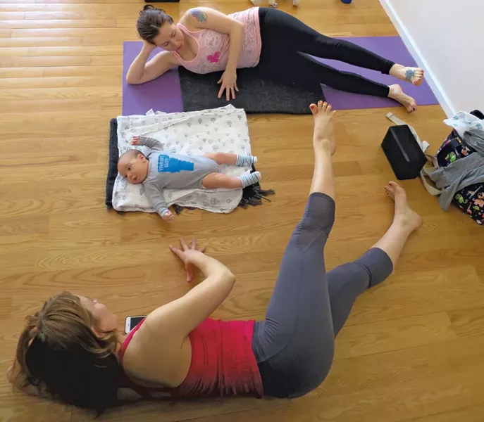 Beth Kruger instructs new mom Sarah Cohn with 8-week-old son, Sam - MATTHEW THORSEN