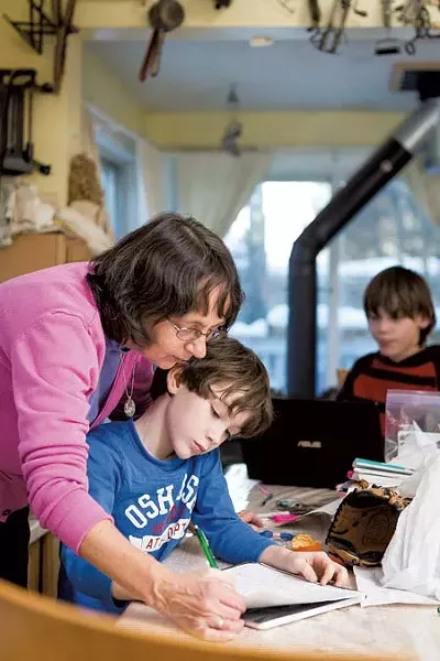 Hamlin helps Zachary, 8, with homework