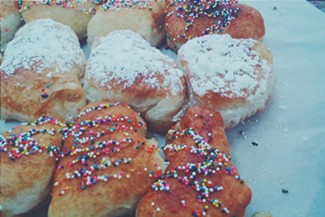 Fried dough with sprinkles and powdered sugar