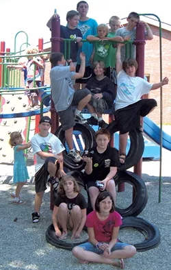 Campers pose on a play structure - COURTESY OF OCCC