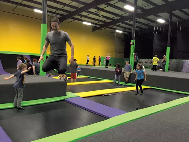 Theo, Jeff and Mira jump in the trampoline field