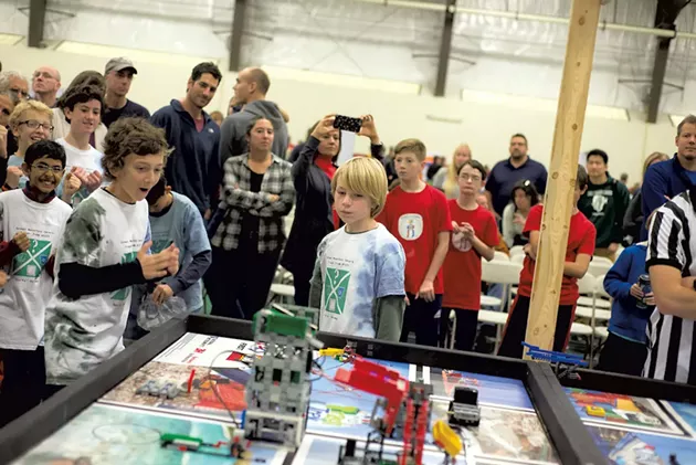 Members of the Green Mountain Gears watching as the irrobot navigates the gameboard at the FIRST LEGO League State Championships last November - COURTESY OF MARK COLLIER