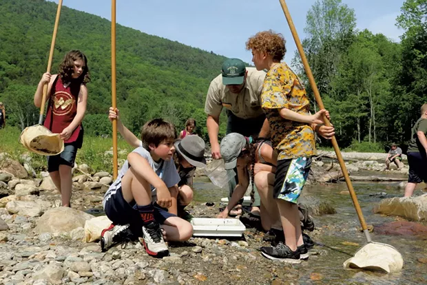 Students look at rainbow and brook trout - TRISTAN VON DUNTZ