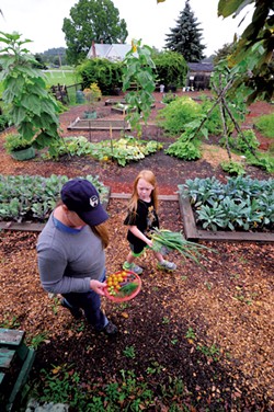 Rowan Moran, 8, and mom, Karen, harvest vegetables - JEB WALLACE BRODEUR