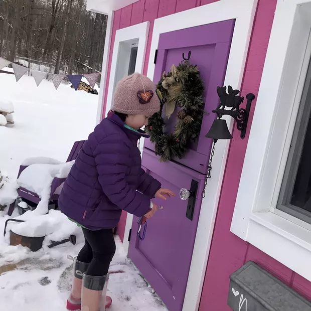 Nora pretends to lock the playhouse door - COURTESY OF JAMIE CUDNEY