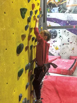 Luke scales the traverse wall - LIZ CADY