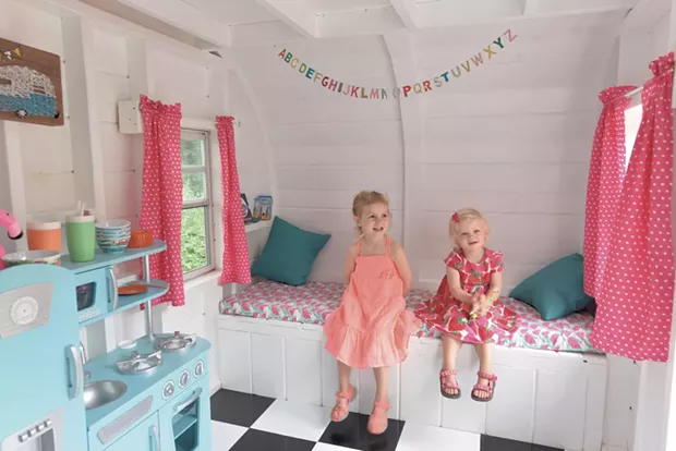 Nora and Claire on a couch covered in watermelon print fabric - COURTESY OF RICH LEVINE