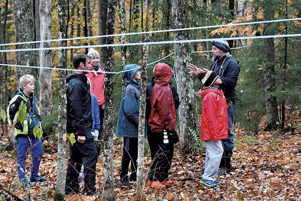 Dave Bennett (right) explains features of the sugar bush to kids from the Community Connections afterschool program, as Elise Bennett and program coordinator Drew McNaughton (second from left) look on. - STEFAN HARD