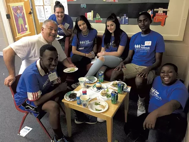 Teens at Sara Holbrook's drop-in center with middle school program director Gabriel Diaz - COURTESY OF SARA HOLBROOK COMMUNITY CENTER