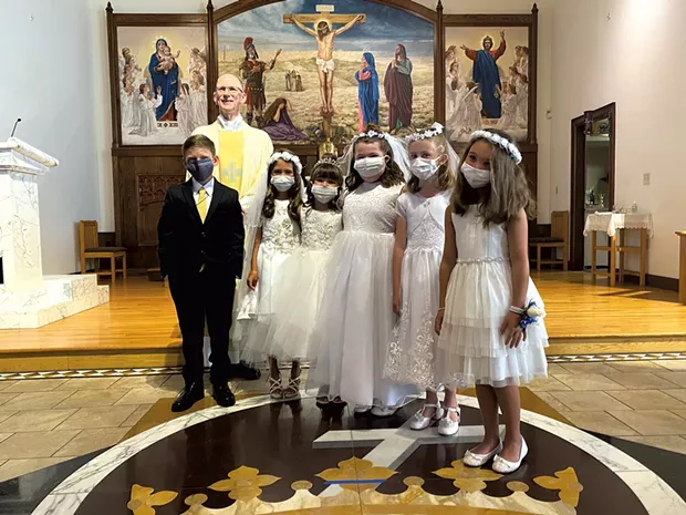 Cameron (left) during his first communion - COURTESY OF KATIE NUNN
