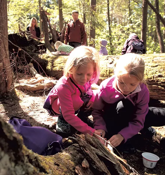 Sisters work together to build a fairy house - MATTHEW THORSEN