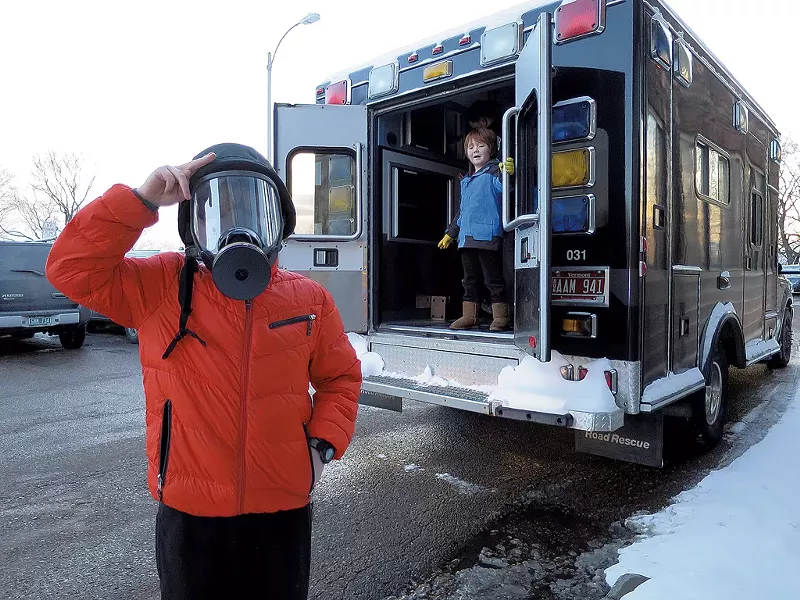 "I'm ready for the zombie invasion!" announced Rob Safran, trying on a police gas mask outside the Burlington Police Department's tactical platform vehicle. - MATTHEW THORSEN