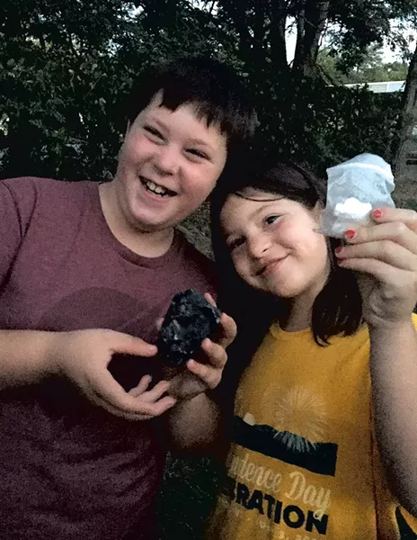 Graham and Ivy with the cache and paper log they found - CATHY RESMER