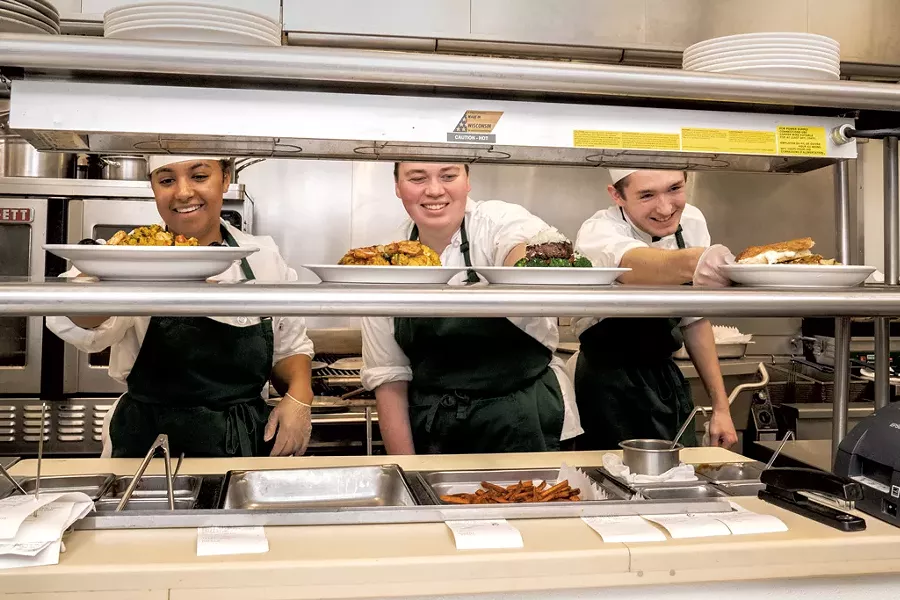 Jojo Williams-Keane, Grace Nadeau and Sam Newland with plates ready to go out - DON WHIPPLE