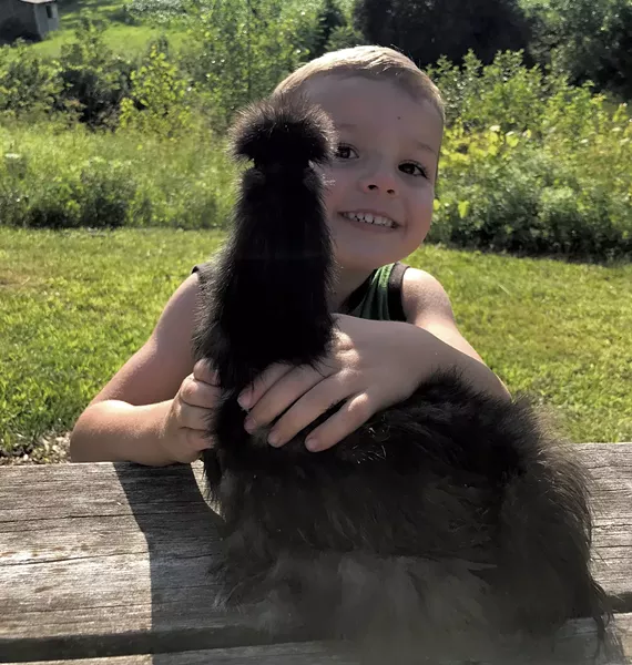 Orion Ronark with a chicken - BRETT ANN STANCIU