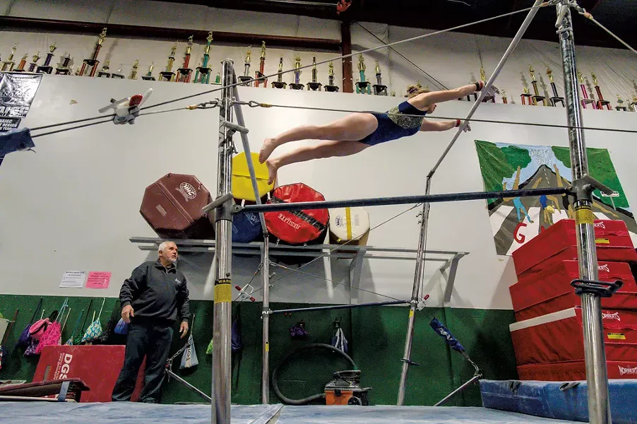 Hruska coaching Bridget Haggerty on the uneven bars - GLENN RUSSELL