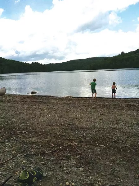 Will and Cullen Mezitt skip stones at Waterbury Reservoir