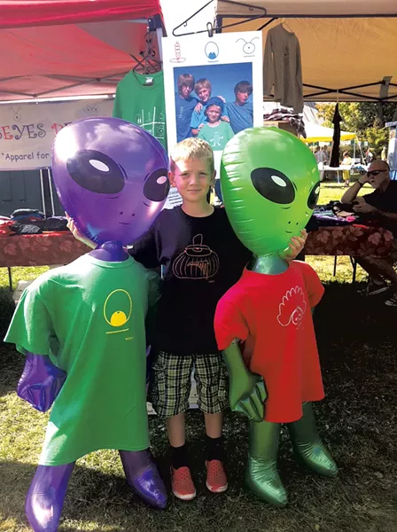 Wyatt selling his T-shirts at a summer market