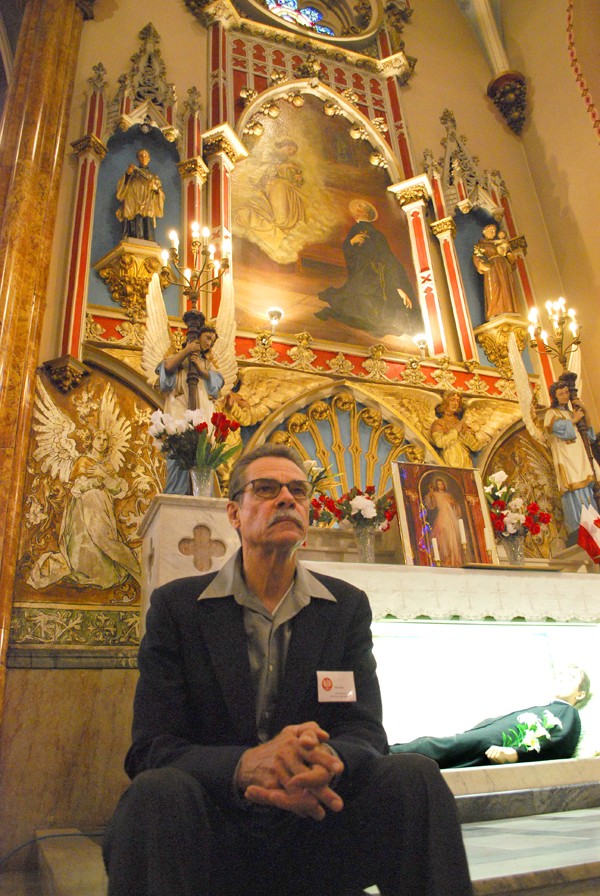 Brian Baka, guardian of the temple, sits by the mannequin of St. Stanislaus' corpse. - DETROITBLOGGER JOHN
