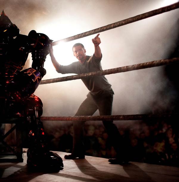 Hugh Jackman points through a mess of CGI robocarnage.