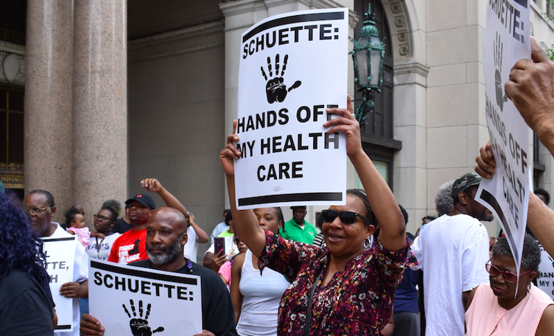 Protesters fight Medicaid work requirements outside the Detroit office gubernatorial candidate and Attorney General Bill Schuette in May. - COURTESY PHOTO