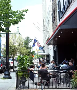 Lunchtime diners hang out on the outdoor patio at Blackstone's Pub& Grill in downtown Flint. - SCOTT ATKINSON