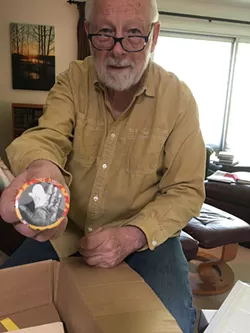 Ken Mikolowski, holding a button depicting poet Jim Gustafson’s bandaged hand, will give a talk commemorating the 50th anniversary of the Alternative Press. - COURTESY OF MEREDITH COUNTS