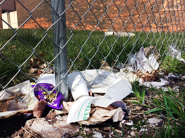 Trash along one of Henry Velleman's fences pictured earlier this spring. - PHOTO BY TOM PERKINS