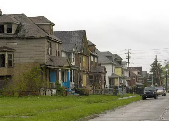 A row of dilapidated houses at Crane and Charlevoix on Detroit’s east side. Eleven houses on this block have been foreclosed since 2002. - STEVE NEAVLING