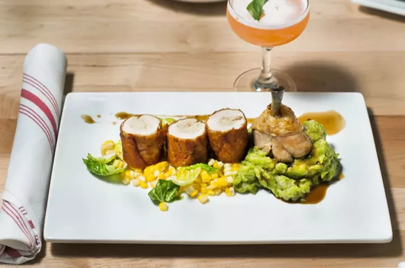 Fried chicken roulade, braised chicken leg, pesto mashed potatoes, corn, Brussel's sprouts, chicken jus - TOM PERKINS