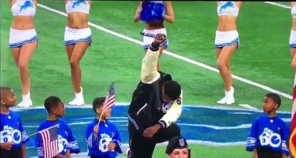 Singer Rico Lavelle kneels while singing the national anthem in solidarity with athletes like Colin Kaepernick, who are protesting police brutality. - SCREENSHOT