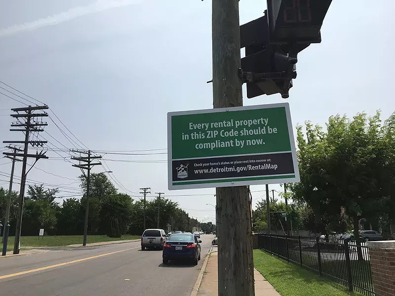 A city notice tells residents in Detroit's 48215 that all properties in the area must be up to code. - VIOLET IKONOMOVA