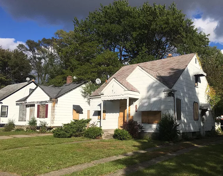 Which house is in worse shape? According to the Land Bank, the one on the right, with a hole in its side, is “unlikely to be blighted.” The one on the left is “likely to be blighted.” - VIOLET IKONOMOVA