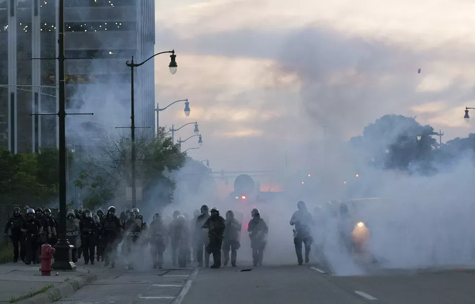 Detroit police deploy tear gas and rubber bullets as protesters flee. - STEVE NEAVLING