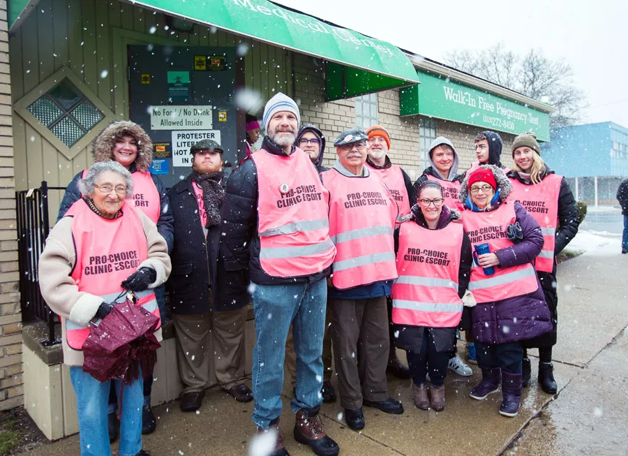 Members of the Greater Detroit chapter of the Democratic Socialists of America gather to escort women seeking abortions into a local clinic. - NICK HAYES
