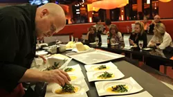 Zazios' executive chef Matt Schellig cooks at the Chef's Table for a group of diners - ROB WIDDIS