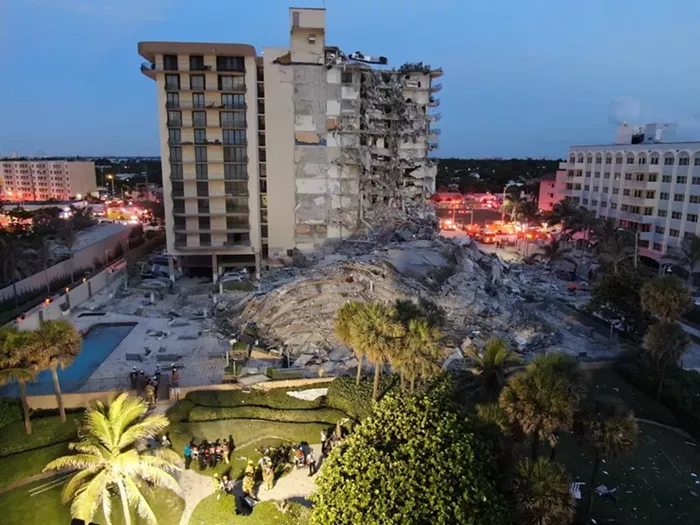 An early-morning view of the devastation from the Champlain Towers condo collapse in Surfside. - PHOTO BY MIAMI-DADE FIRE RESCUE VIA TWITTER