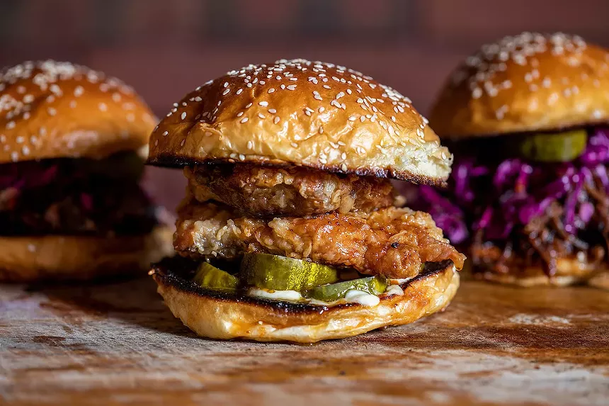 Izzy's Brooklyn Smokehouse sandwich includes a popular fried smoked chicken sandwich and a pulled beef topped with coleslaw, pickles and the house barbecue sauce. - PHOTOGRAPH OF IZZY'S BROOKLYN SMOKEHOUSE
