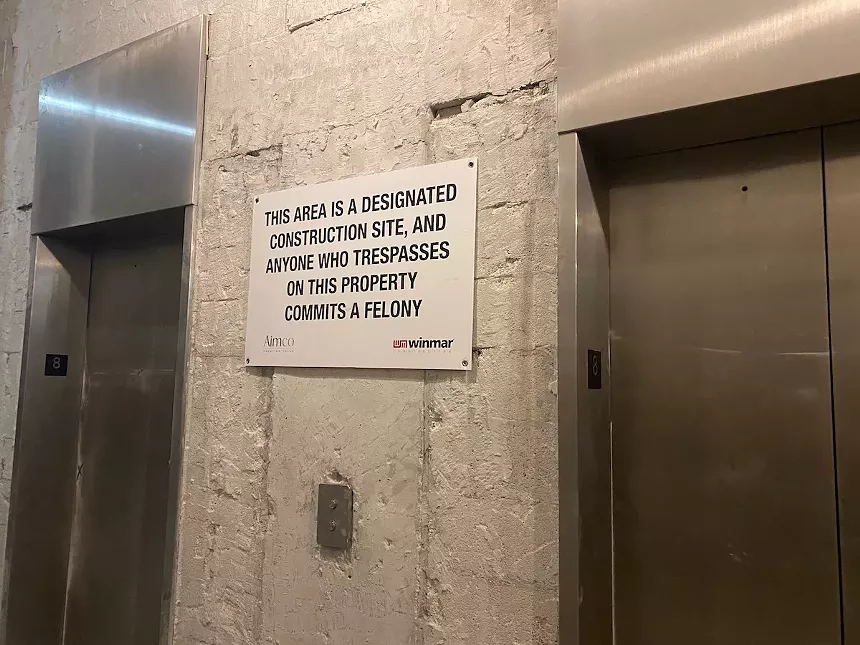 Signs state that the area is a "designated construction site" and that "anyone who trespasses on the property commits a felony." - PHOTO BY JESS SWANSON