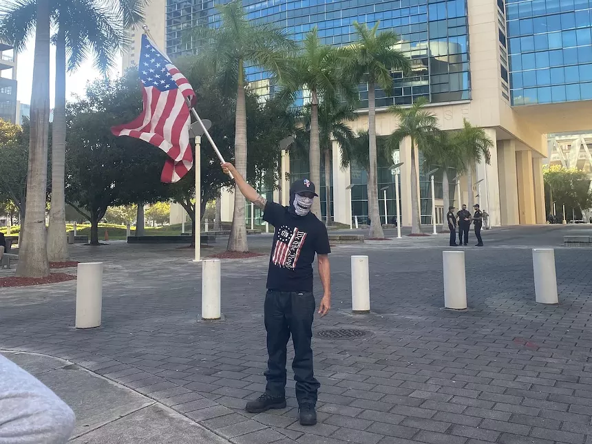 An attendee waves an American flag. See more photos from the Jan. 6 gathering here. - PHOTO BY JESS SWANSON